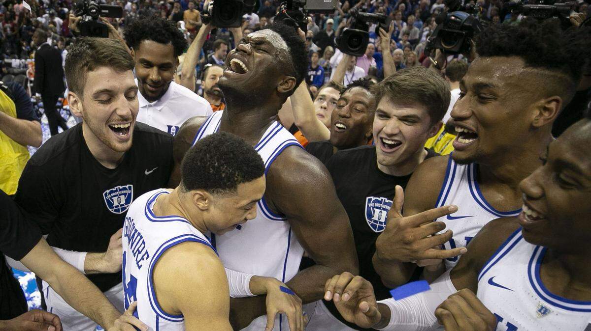 Duke’s Zion Williamson (1) embraces teammate Jordan Goldwire (14) and celebrates with his teammates after clinching the ACC Tournament championship game with a 73-63 victory over Florida State on Saturday, March 16, 2019 at the Spectrum Center in Charlotte, N.C. Williamson scored 21 points and was need the tournament MVP.