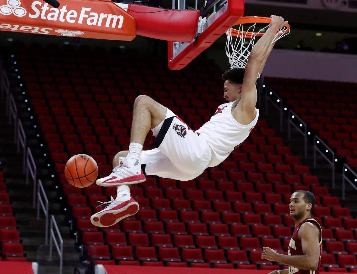 N.C. State’s Jericole Hellems (4) slams in two during the first half of N.C. State’s game against Boston College at PNC Arena in Raleigh, N.C., Wednesday, December 30, 2020.
