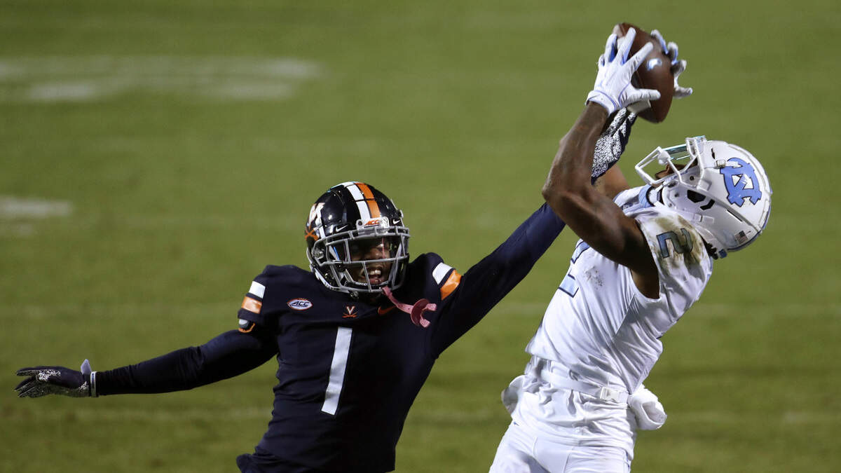 UNC’s Dyami Brown (2) grabs a pass over Virginia defender Nick Grant (1) to set up a fourth quarter touchdown for the trailing Tar Heels Saturday night, Oct. 31, 2020.