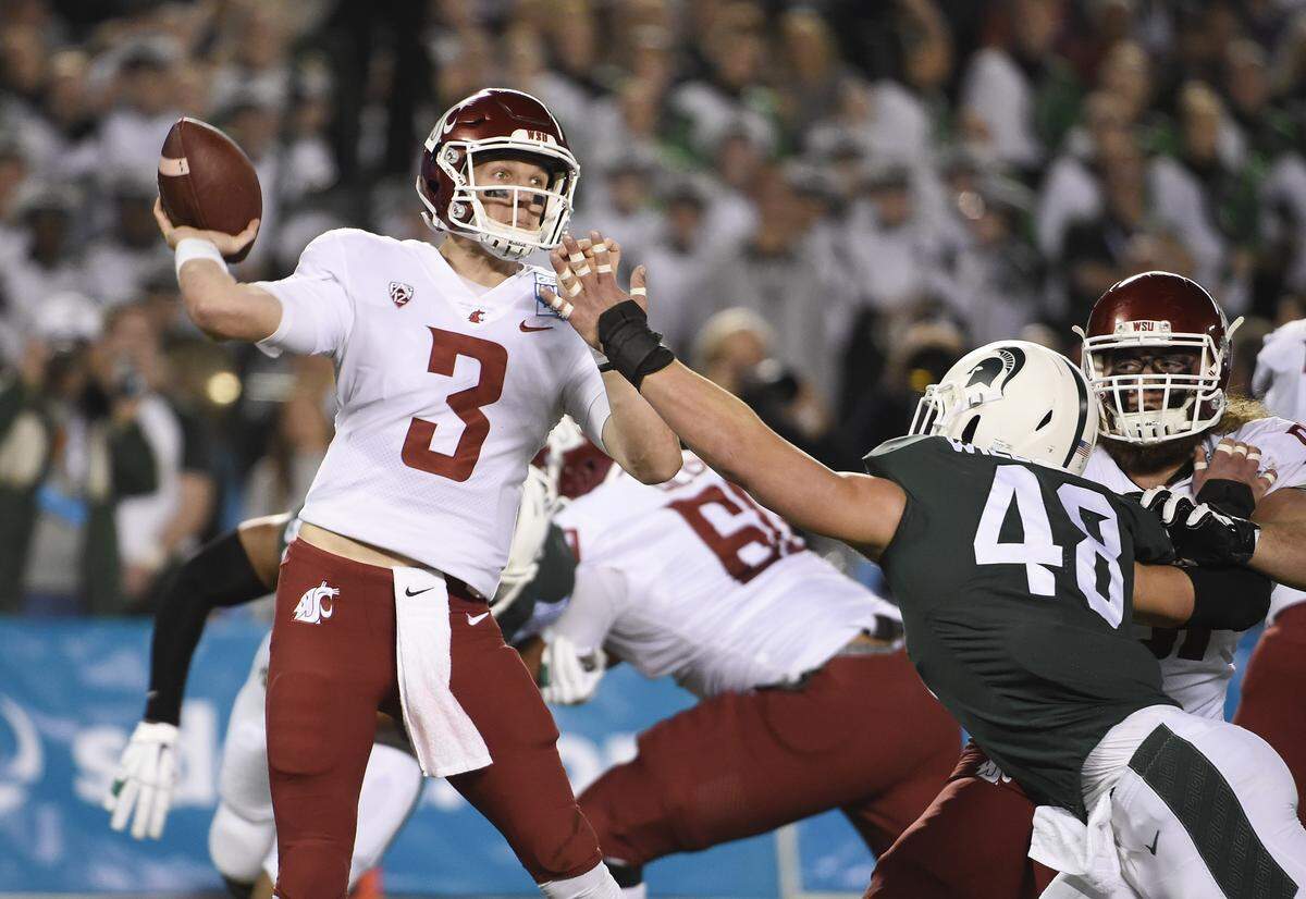 Washington State quarterback Tyler Hilinski throws under pressure from Michigan State defensive end Kenny Willekes (48) during the first half of the Holiday Bowl NCAA college football game Thursday, Dec. 28, 2017, in San Diego.