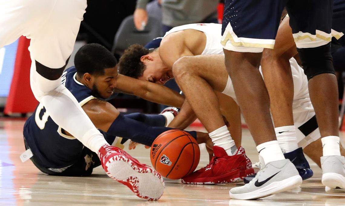 N.C. State’s Jericole Hellems (4) and Charleston Southern’s Travis Anderson (0) go after the loose ball during N.C. State’s game against Charleston Southern in the Wolfpack Invitational at Reynolds Coliseum in Raleigh, N.C., Wednesday, Nov. 25, 2020.