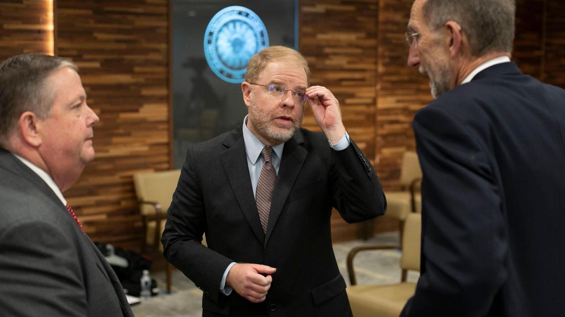 Newly elected UNC System President Peter Hans, center, talks with Randall Ramsey, chairman of the Board of Governors, left, and interim President Dr. William Roper following his election on Friday, June 19, 2020 in Chapel Hill, N.C.