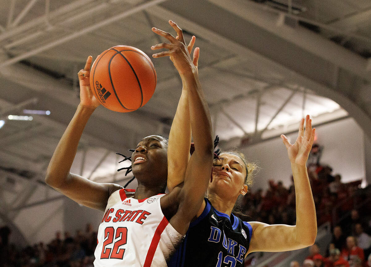 N.C. State’s Saniya Rivers pulls down a rebound away from Duke’s Delaney Thomas during the first half of the Wolfpack’s game on Sunday, Jan. 21, 2024, at Reynolds Coliseum in Raleigh, N.C.