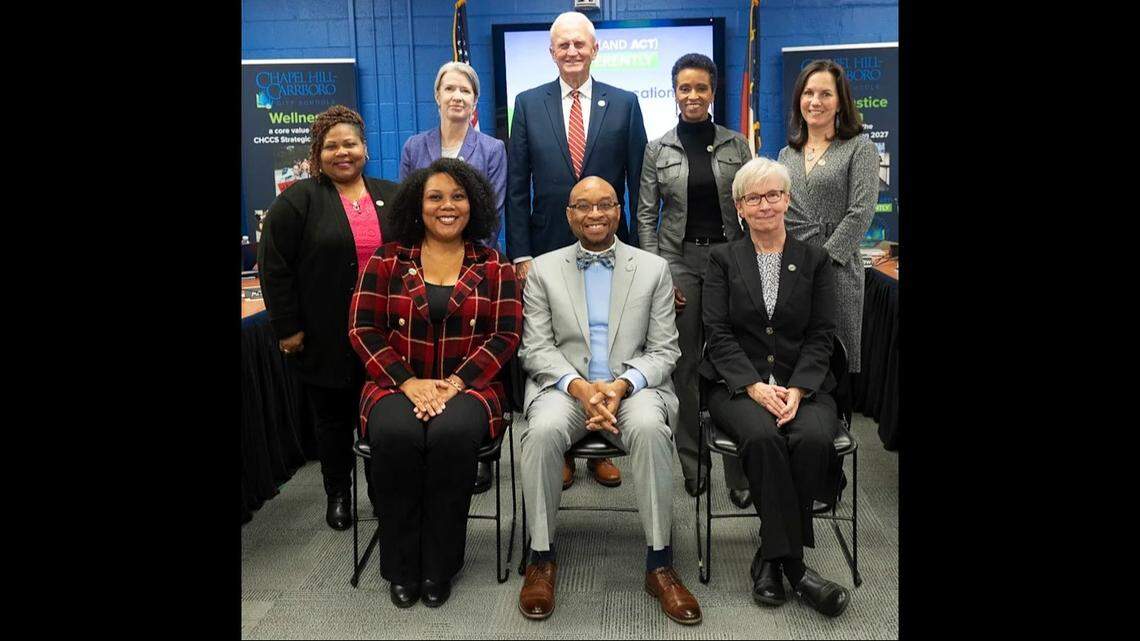 Chapel Hill-Carrboro Superintendent Rodney Trice is flanked by board members: Riza Jenkins (clockwise from bottom left), Vickie Feaster Fornville, Melinda Manning, George Griffin, Rani Dasi, Meredith Ballew, and Barbara Fedders.