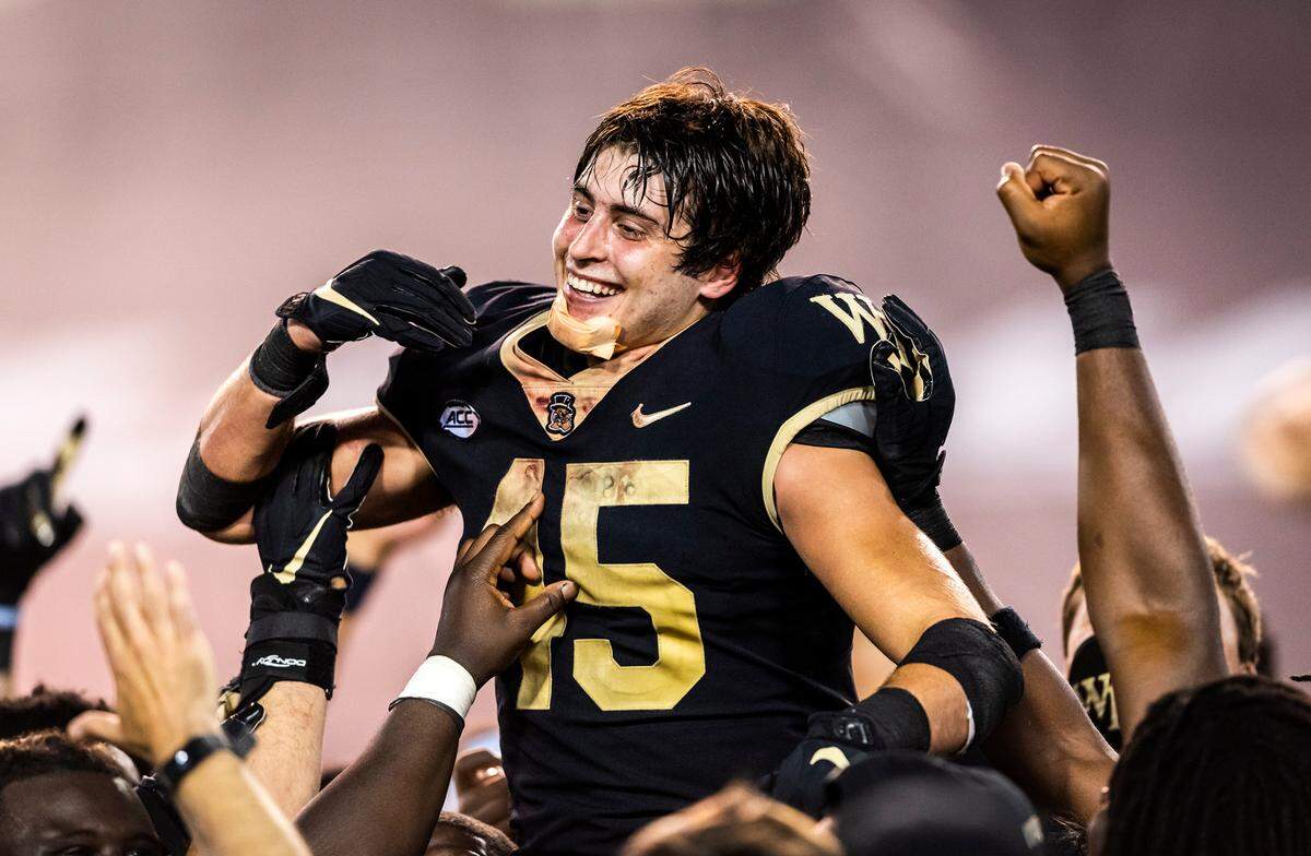 Wake Forest freshman defensive back Nick Andersen (45) is hoisted in the air by his teammates after the Demon Deacons defeated 19th-ranked Virginia Tech 23-16 behind Andersen’s three interceptions on Saturday, Oct. 24, 2020 at Truist Field in Winston-Salem, N.C.