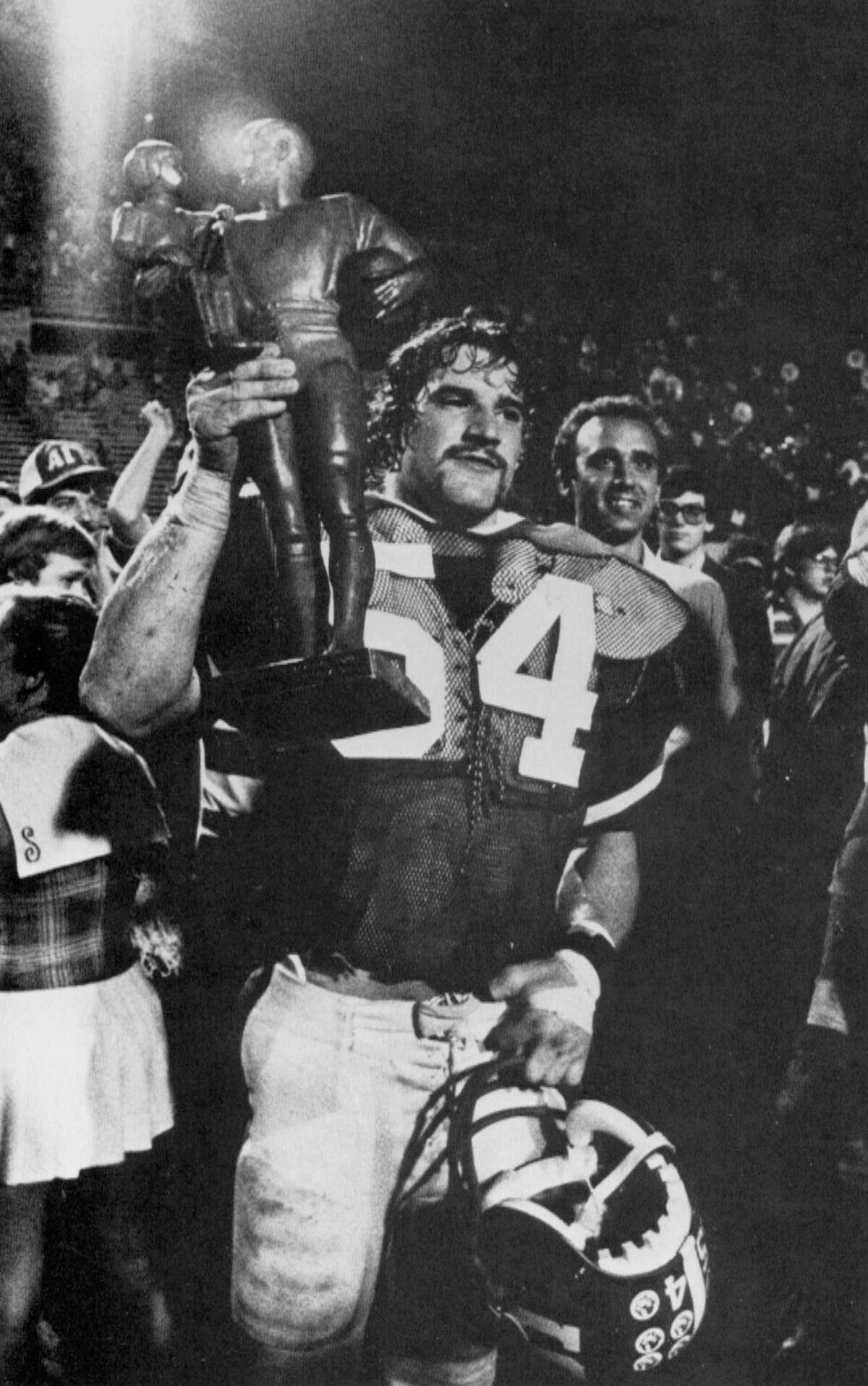 N.C. State’s Bill Cowher raises a trophy after the Wolfpack defeated the Pittsburgh Panthers in the Tangerine Bowl in 1978.