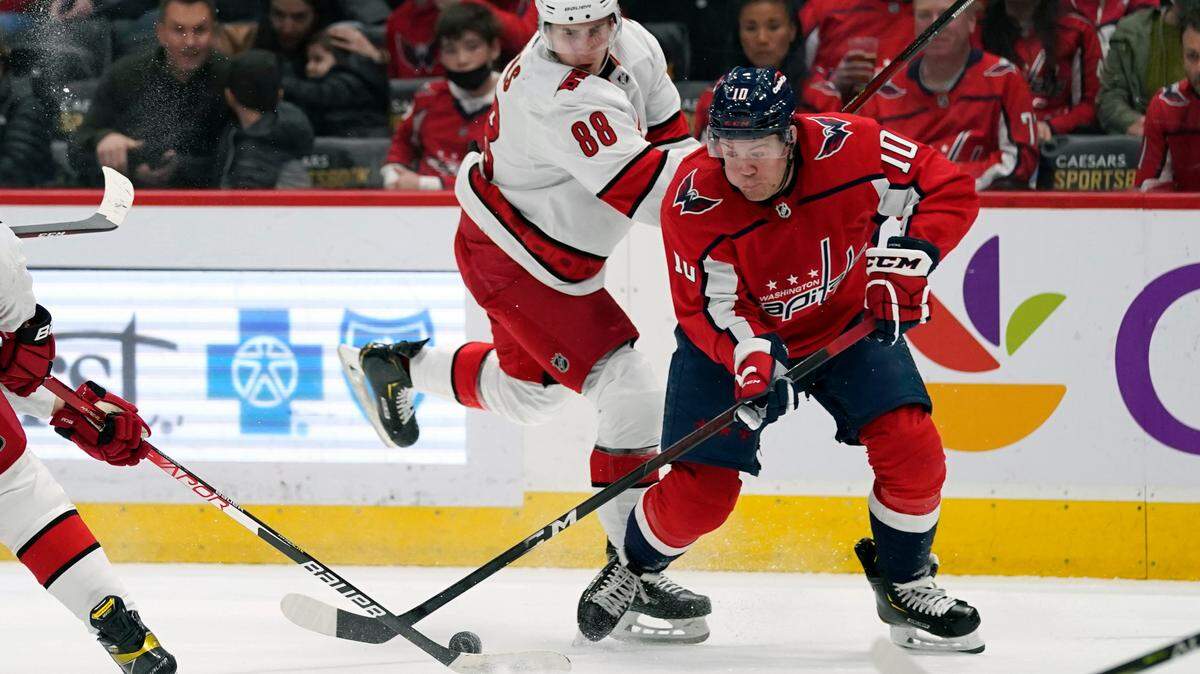 Carolina Hurricanes center Martin Necas (88) fights Washington Capitals right wing Daniel Sprong (10) for the puck during the first period of an NHL hockey game, Thursday, March 3, 2022, in Washington. (AP Photo/Evan Vucci)