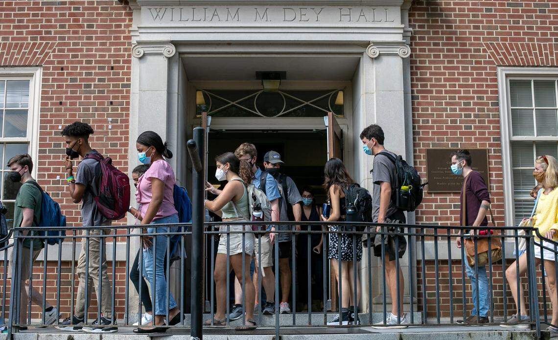 University of North Carolina students file in and out of Dey Hall during the first day of classes on Wednesday, August 18, 2021 in Chapel Hill, N.C. Thousands of students have returned to campus amid a surge in COVID-19 cases.