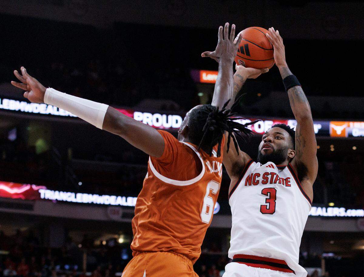 N.C. State’s Dontrez Styles shoots over Texas’ Arthur Kaluma during the first half of the Wolfpack’s 63-59 loss on Wednesday, Dec. 4, 2024, at Lenovo Center in Raleigh, N.C.
