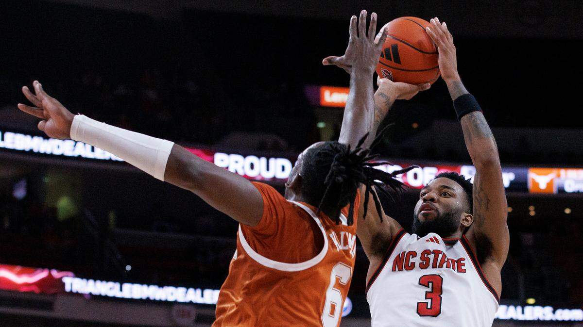 N.C. State’s Dontrez Styles shoots over Texas’ Arthur Kaluma during the first half of the Wolfpack’s 63-59 loss on Wednesday, Dec. 4, 2024, at Lenovo Center in Raleigh, N.C.