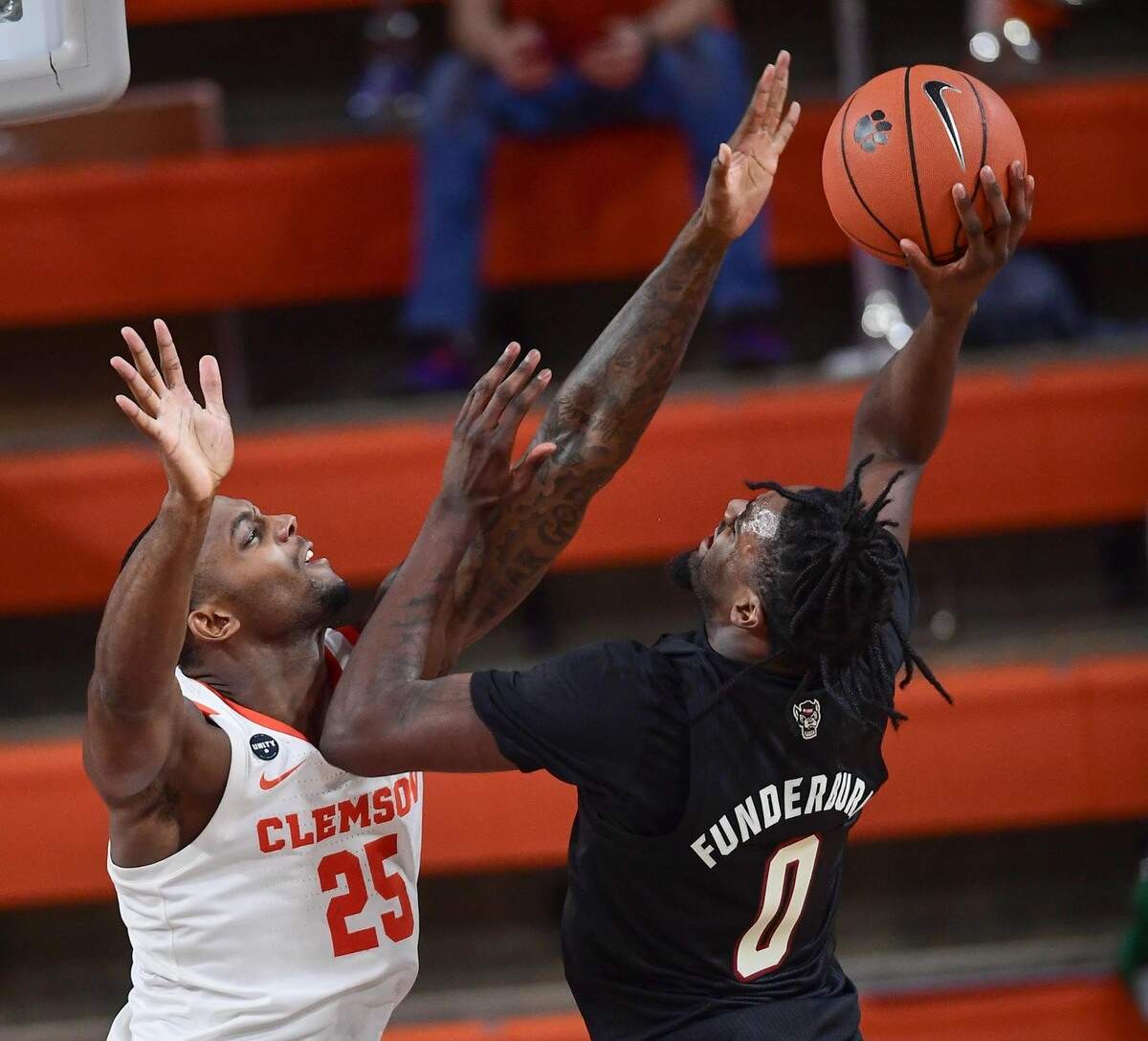 Clemson senior forward Aamir Simms(25) defends NC State forward D.J. Funderburk (0) during their game on January 5, 2021.