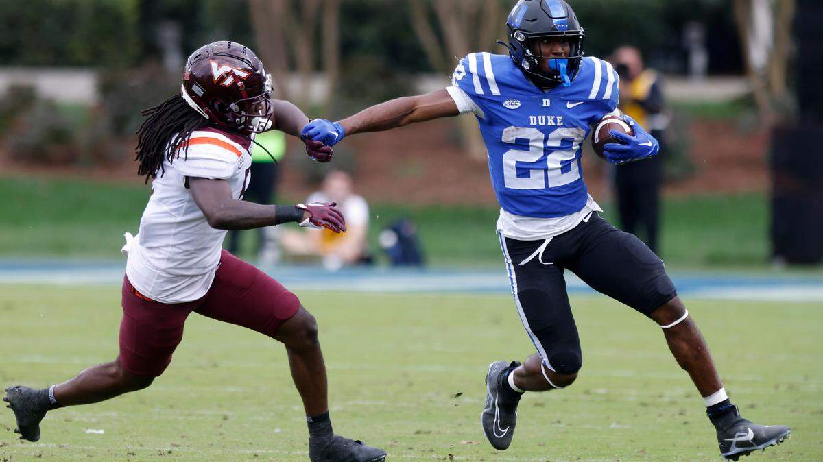 Duke Blue Devils running back Jaylen Coleman runs the ball past Virginia Tech Hokies defensive back Nasir Peoples during the second half of a football game at Wallace Wade Stadium on Saturday, Nov. 12, 2022, in Durham, N.C.