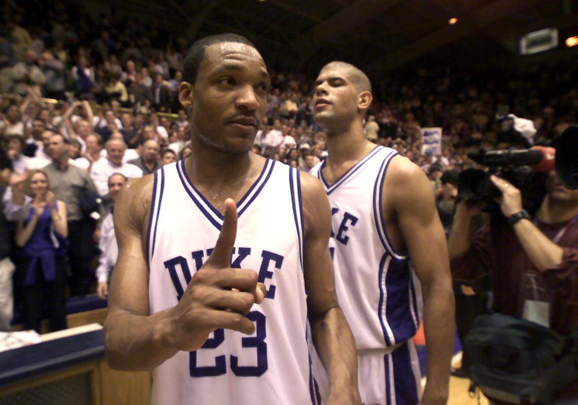 Duke's Chris Carrawell shows the media who's the best in the ACC with teammate Shane Battier in the background in 2000. Duke defeated Wake Forest 96-78, clinching the ACC regular-season title for the fourth consecutive year.