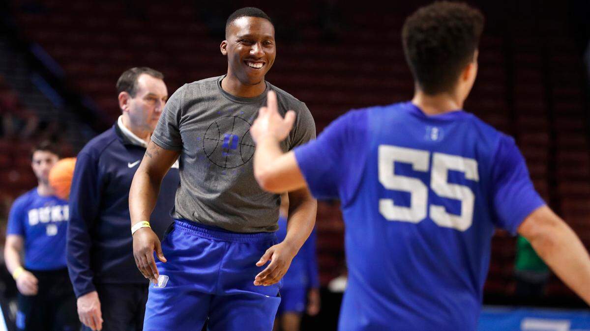 Duke assistant coach Nolan Smith laughs with Spencer Hubbard (55) during the Blue Devils’ open practice at the Bon Secours Wellness Arena in Greenville, S.C., Thursday, March 17, 2022.