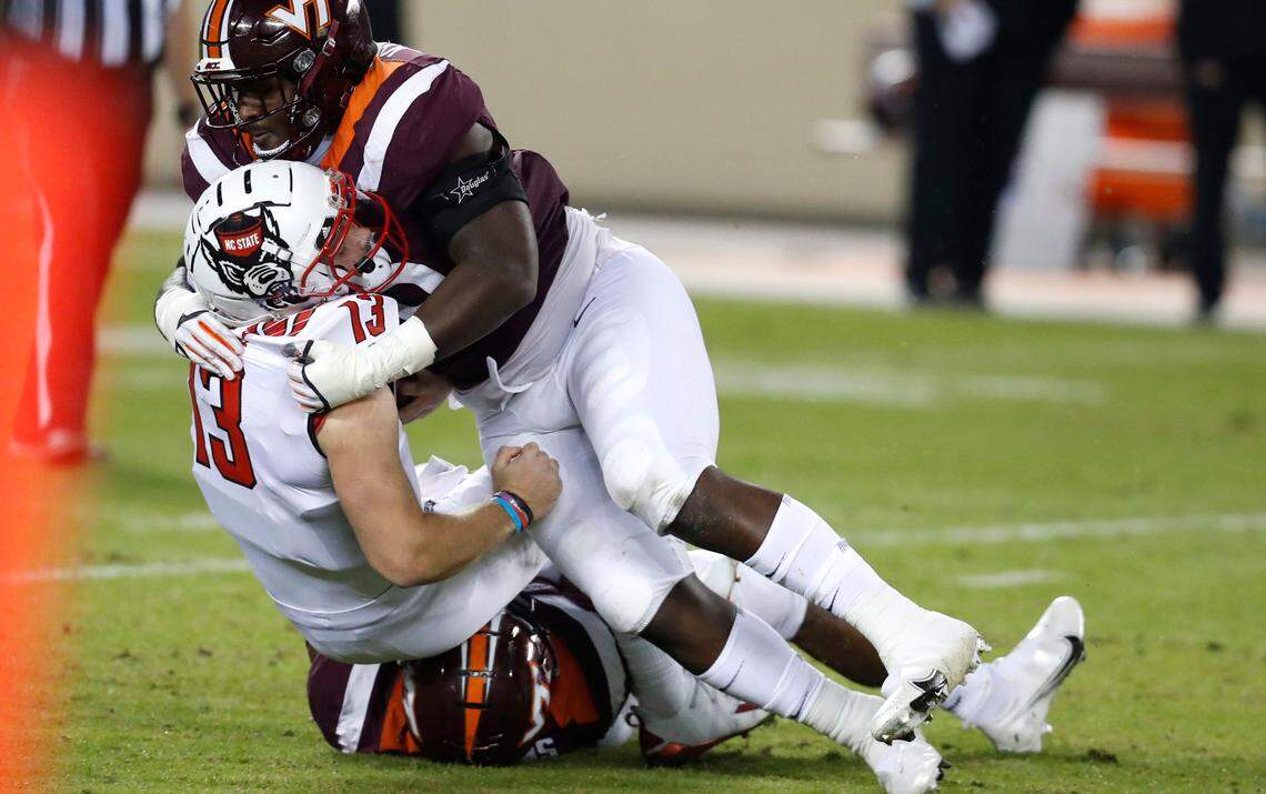 N.C. State quarterback Devin Leary (13 is sacked by Virginia Tech defensive lineman Mario Kendricks (93) during the second half of Virginia Tech’s 45-24 victory over N.C. State at Lane Stadium in Blacksburg, VA Saturday, Sept. 26, 2020.