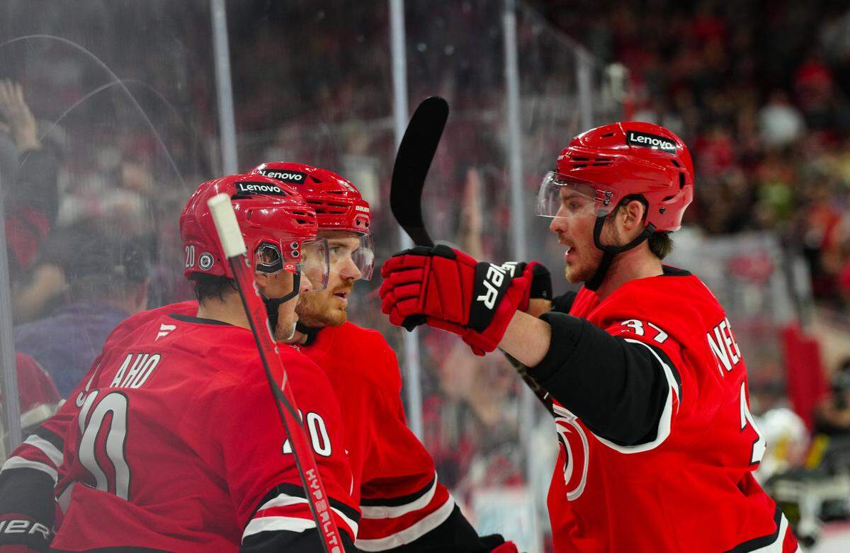 Nov 7, 2024; Raleigh, North Carolina, USA; Carolina Hurricanes center Jack Roslovic (96) is congratulated by center Sebastian Aho (20) and right wing Andrei Svechnikov (37) during the first period at Lenovo Center.