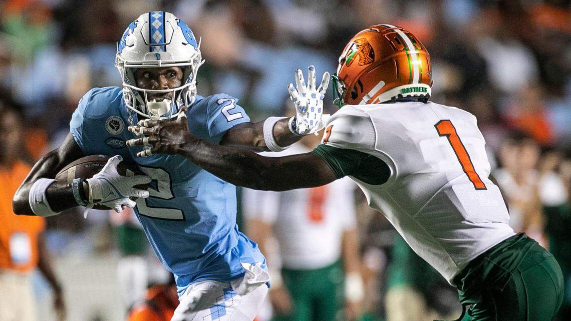 North Carolinaís Gavin Blackwell (2) picks up 12 yards against Florida A&Mís Love Jenkins (1) after a pass from quarterback Drake Maye in the second quarter on Saturday, August 27, 2022 at Kenan Stadium in Chapel Hill, N.C.
