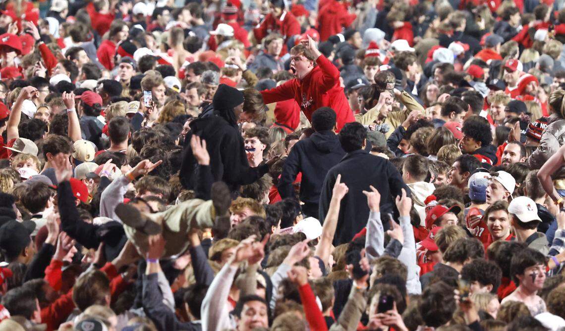 Fans celebrate after rushing the field after N.C. State’s 48-36 victory over Georgia Tech at Carter-Finley Stadium in Raleigh, N.C., Saturday, Nov. 1, 2025.