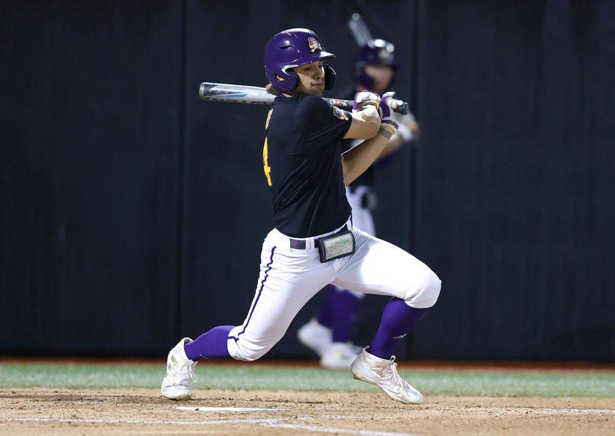 East Carolina’s Zach Agnos (14) singles in the bottom of the first inning during ECUs game against Texas in the Greenville Super Regional at Clark-LeClair Stadium Sunday, June 12, 2022.