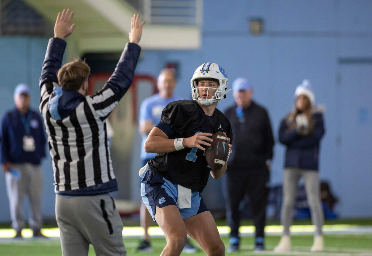 North Carolina graduate transfer quarterback Max Johnson (14) looks for a receiver during the Tar Heels’ opening day of spring football practice on Tuesday, March 19, 2024 in Chapel Hill, N.C.