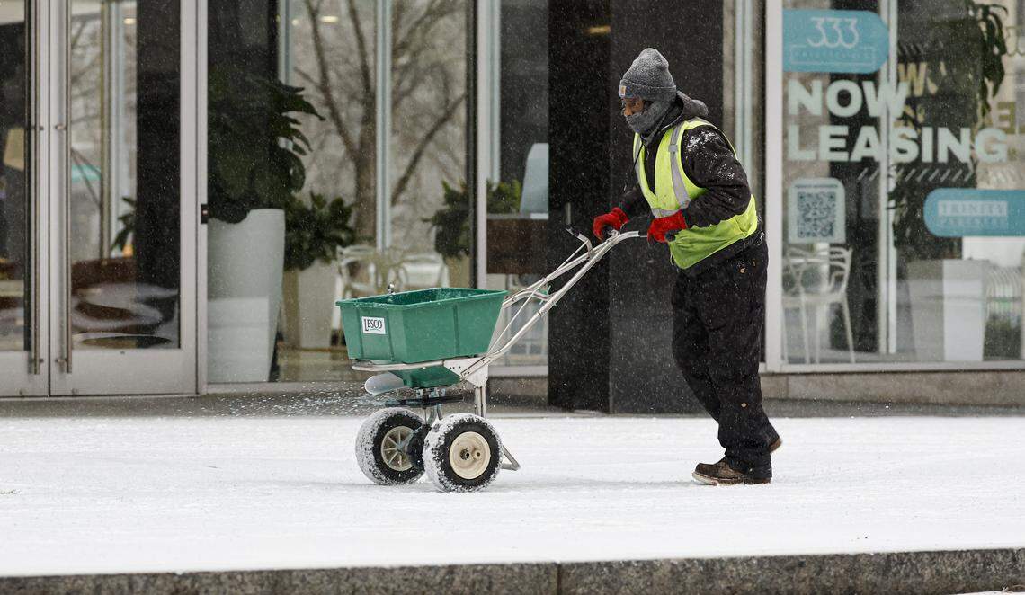 Brandon Chapman with the City of Raleigh Department of Transportation applies ice melt in downtown Raleigh Sunday morning, Jan. 25, 2026.