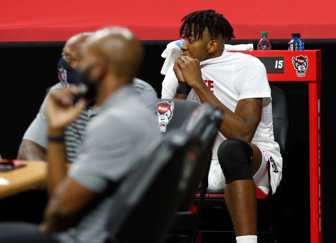 N.C. State’s Manny Bates (15) watches from the bench during the second half of N.C. State’s 79-76 victory over Boston College at PNC Arena in Raleigh, N.C., Wednesday, December 30, 2020.