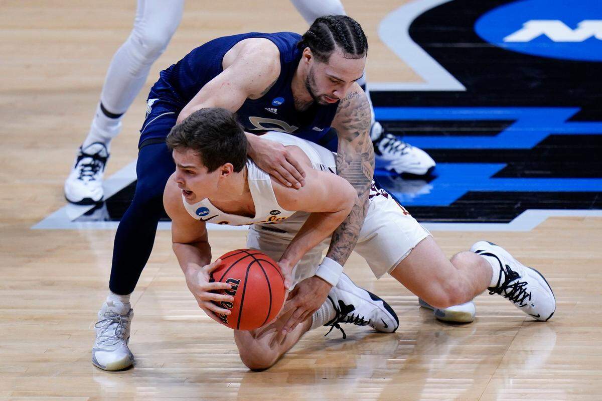 Loyola Chicago guard Braden Norris, bottom, fights forthe ball with Georgia Tech forward Moses Wright in the second half of a college basketball game in the first round of the NCAA tournament at Hinkle Fieldhouse in Indianapolis, Friday, March 19, 2021. 
