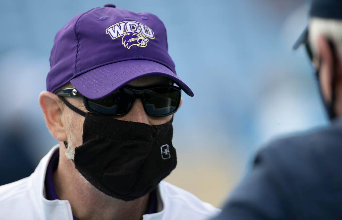 Western Carolina head coach Mark Speir talks with North Carolina coach Mack Brown prior to their game on Saturday, December 5, 2020 at Kenan Stadium in Chapel Hill, N.C.