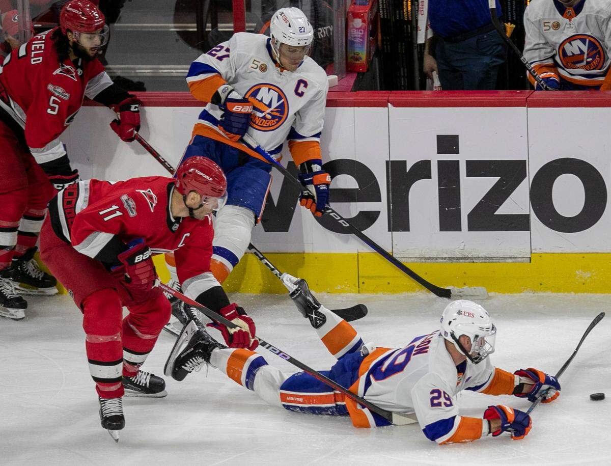 New York Islanders’ Brock Nelson (29) is checked to the ice as he and Carolina Hurricanes’ Jordan Staal (11) go after the puck in the second during game two of their Stanley Cup series on Wednesday, April 19, 2023 at PNC Arena in Raleigh, N.C.