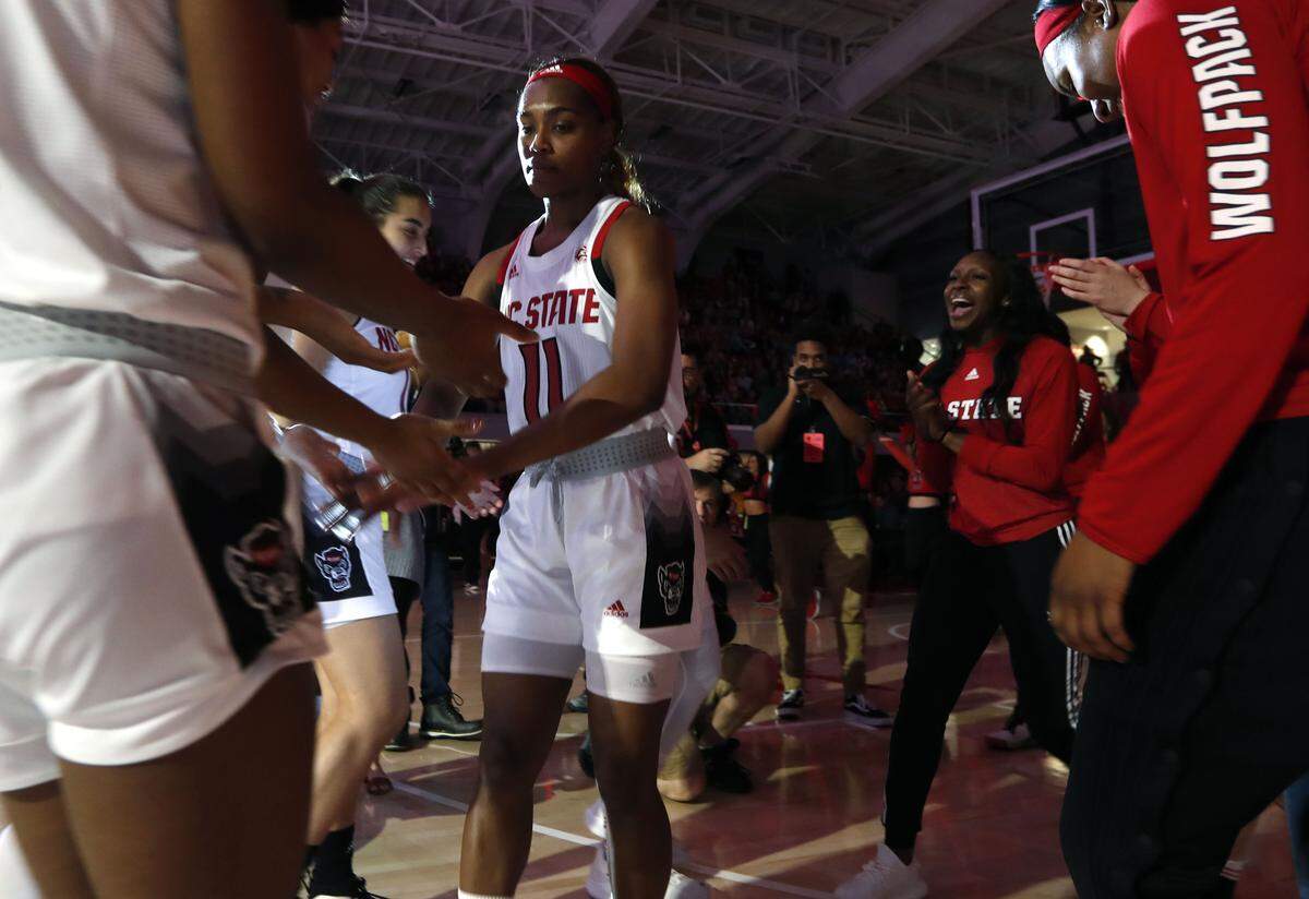 N.C. State’s Kiara Leslie (11) greets teammates during introductions before N.C. State’s game against UNC at Reynolds Coliseum in Raleigh, N.C., Sunday, Feb. 3, 2019.