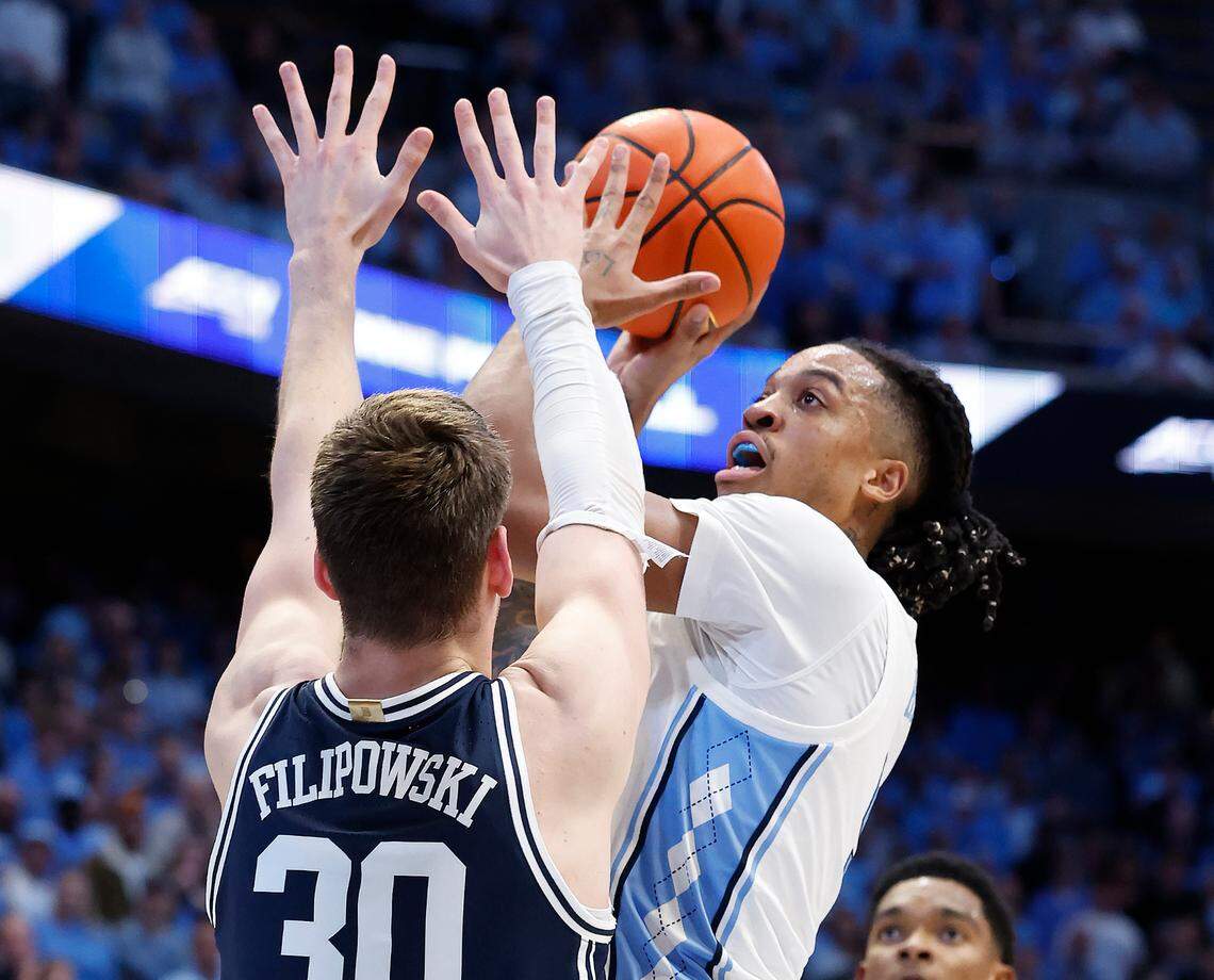North Carolina’s Armando Bacot (5) shoots as Duke’s Kyle Filipowski (30) defends during the first half of Duke’s game against UNC at the Smith Center in Chapel Hill, N.C., Saturday, Feb. 3, 2024.