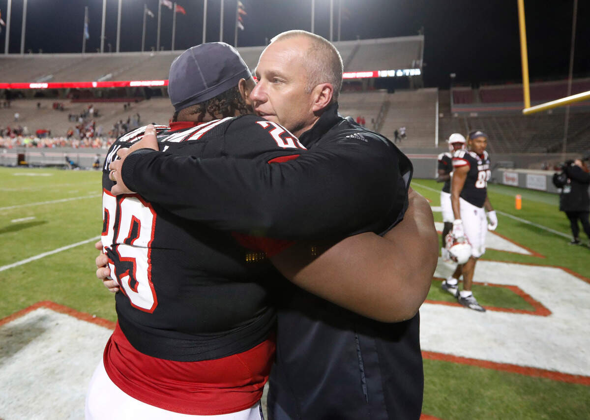 N.C. State head coach Dave Doeren hugs defensive tackle Alim McNeill (29) after N.C. State’s 23-13 victory over Georgia Tech at Carter-Finley Stadium in Raleigh, N.C., Saturday, Dec. 5, 2020.