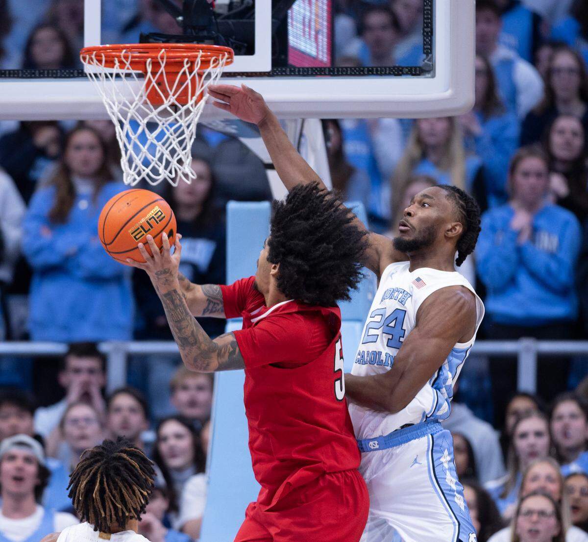 North Carolina’s Jae’Lyn Withers (24) defends Louisville’s Sky Clark (55) in the first half on Wednesday, January 17, 2024 at the Smith Center in. Chapel Hill, N.C.