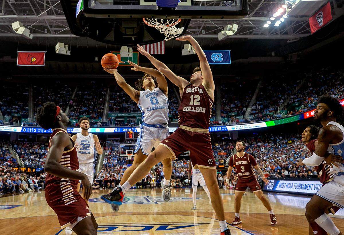 North Carolina’s Seth Trimble (0) drives to the basket against Boston College’s Quinten Post (12)) during the second half in the second round of the ACC Tournament on Wednesday, March 8, 2023 at the Greensboro Coliseum in Greensboro, N.C.