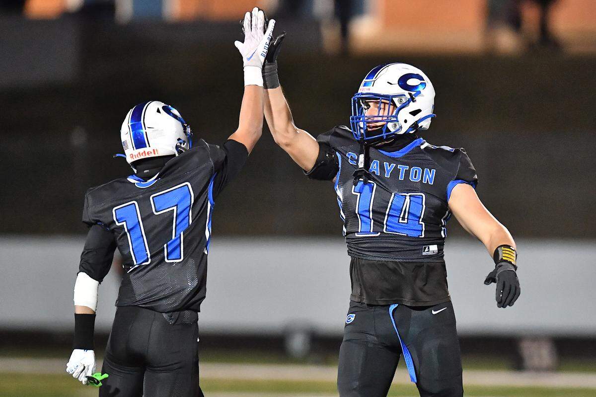 Clayton tight end River Fiore (14) celebrates with  Parker Ferguson (17) after their defeat of Southeast Raleigh in the fourth round of the 7A playoffs. The Clayton Comets and the Southeast Raleigh Bulldogs met in the fourth round of the NCHSAA 7A Playoffs in Clayton, N.C. on November 28, 2025.