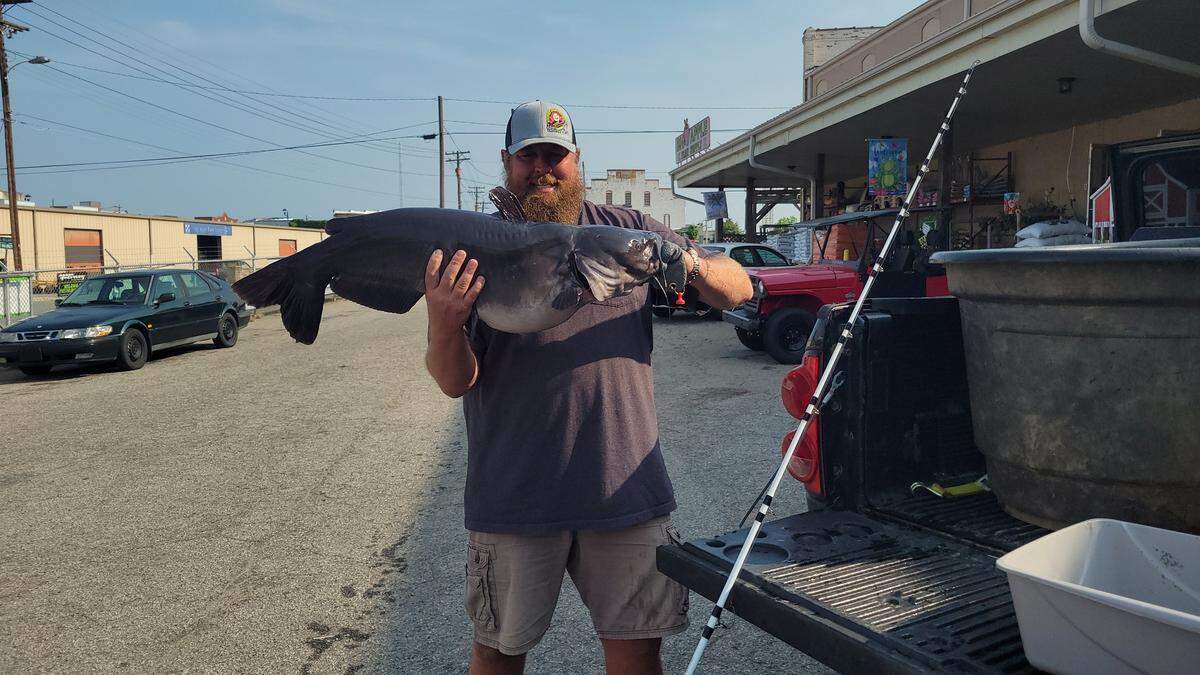 Justin Hall caught the record-breaking 27-pound fish on a farm in North Carolina, photos show.