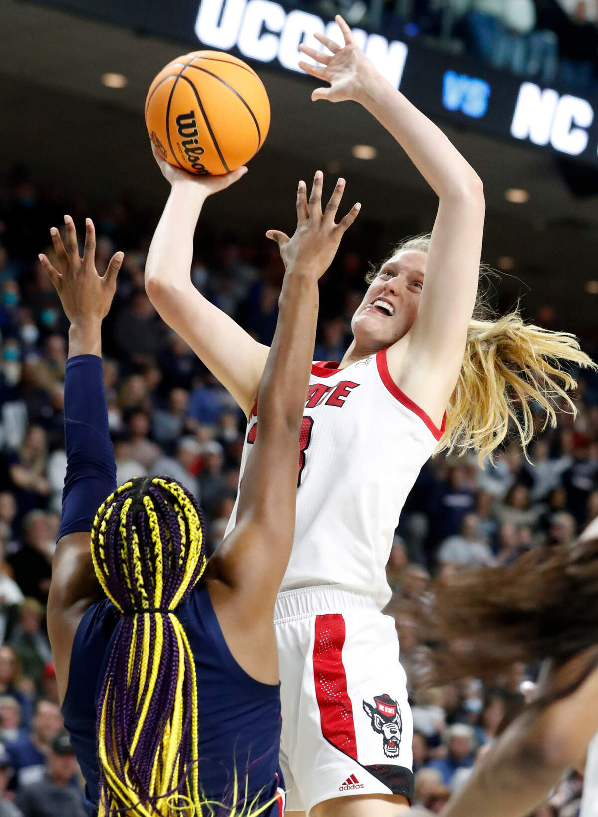 N.C. State’s Elissa Cunane (33) shoots as Connecticut’s Aaliyah Edwards (3) defends during the University of Connecticut’s 91-87 double overtime victory over N.C. State in the Bridgeport Regional final at Total Mortgage Arena in Bridgeport, Conn., Monday, March 28, 2022.