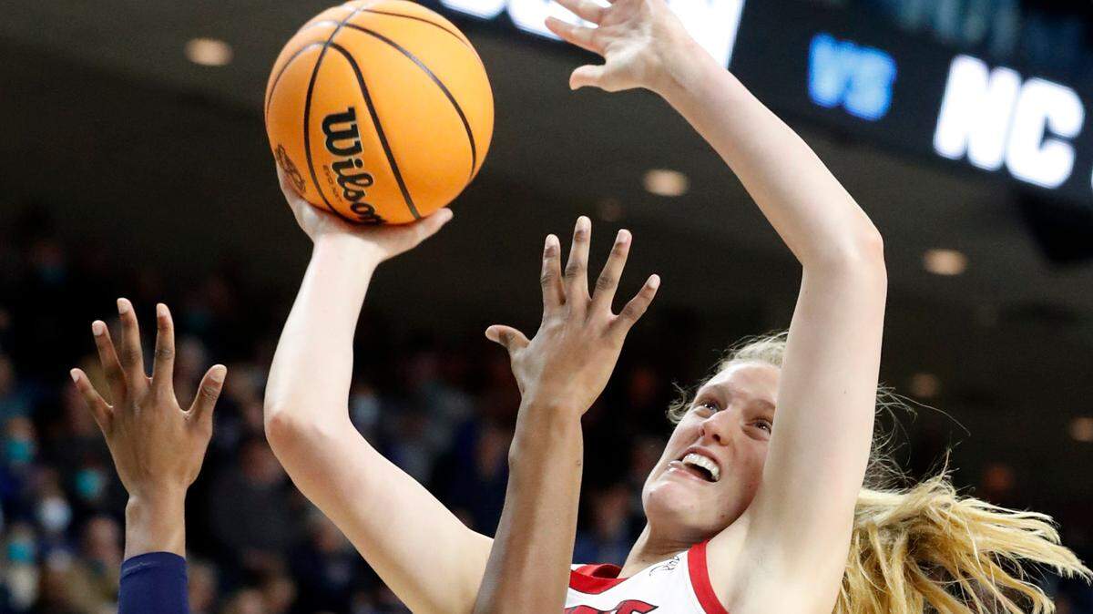 N.C. State’s Elissa Cunane (33) shoots as Connecticut’s Aaliyah Edwards (3) defends during the University of Connecticut’s 91-87 double overtime victory over N.C. State in the Bridgeport Regional final at Total Mortgage Arena in Bridgeport, Conn., Monday, March 28, 2022.