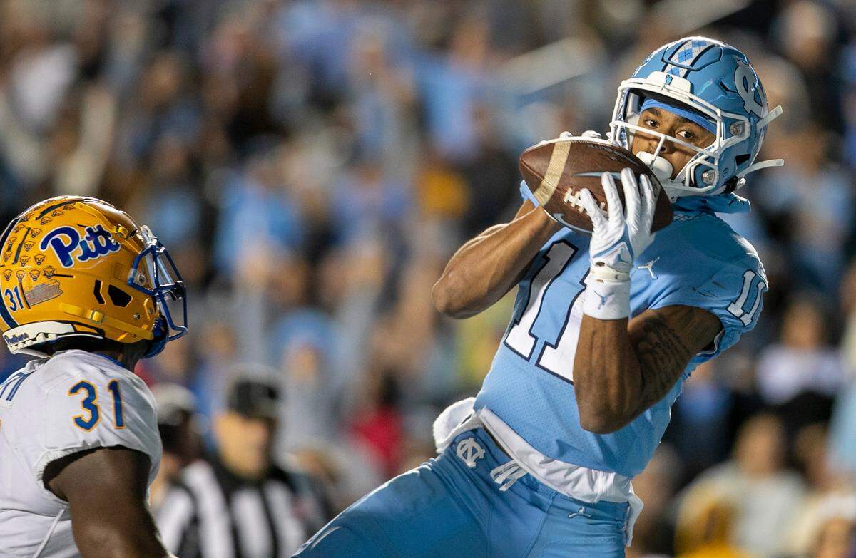 North Carolina’s Josh Downs (11) pulls in a 13-yard pass reception from quarterback Drake Maye for a touchdown ahead of Pitt’s Erick Hallett II (31) in the third quarter on Saturday, October 29, 2022 at Kenan Stadium in Chapel Hill, N.C.