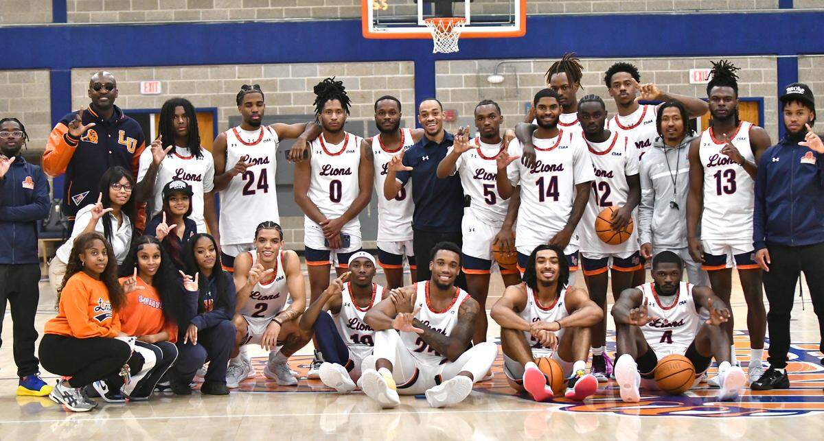 Lincoln University head basketball coach Julius Hodge, left poses with his team during the Lion’s Madness event at the school this month.