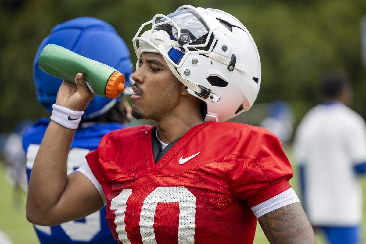 Duke quarterback Darian Mensah cools down during a break in football practice as temperatures climbed into the 90s on Monday, July 28, 2025.