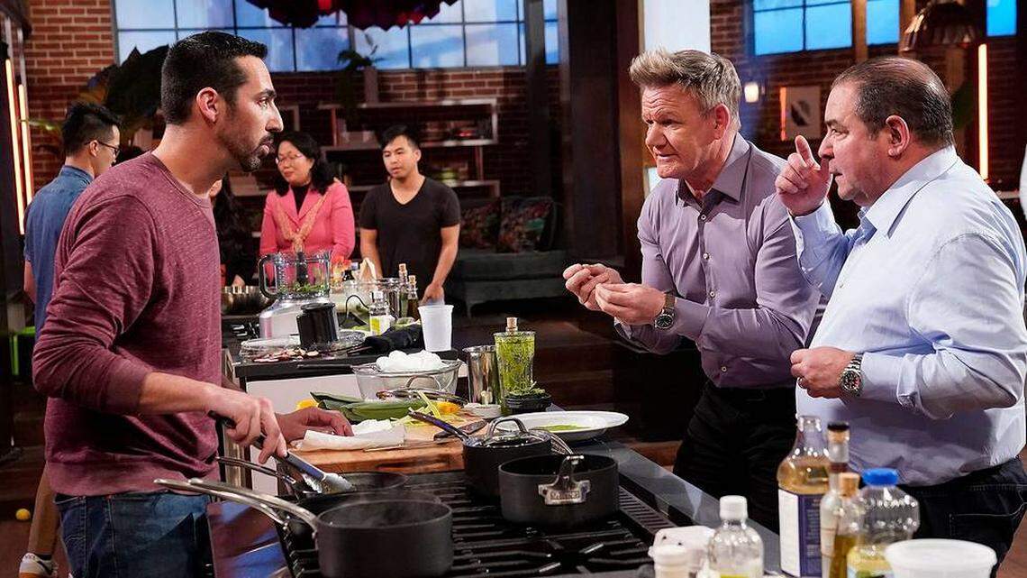 Chef/host Gordon Ramsay, left, and guest judge Emeril Lagasse, right, speak to a contestant in the season premiere of “MasterChef: Legends” on Fox.