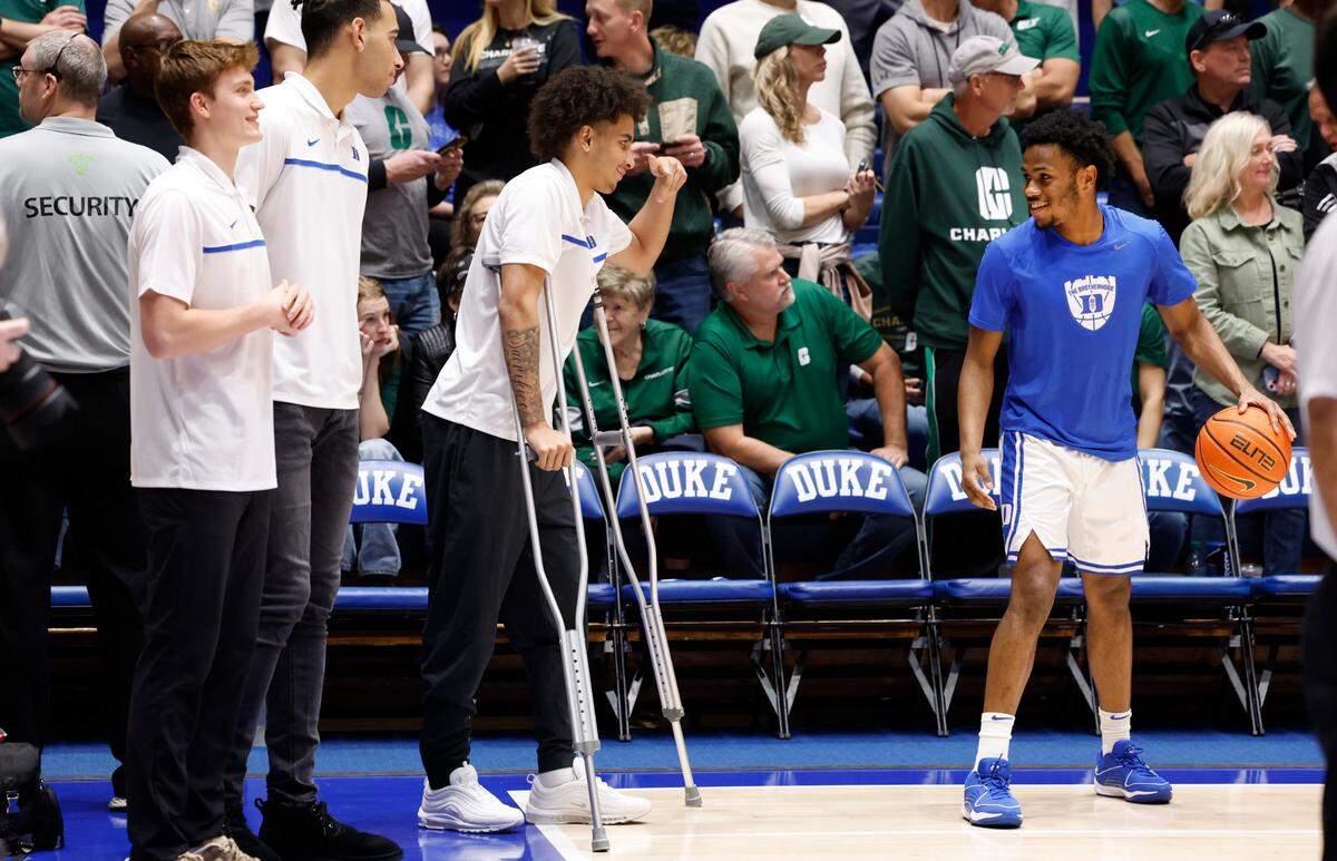 Duke’s Tyrese Proctor talks with Duke’s Jeremy Roach as the team warms up before the Blue Devils’ game against Charlotte at Cameron Indoor Stadium in Durham, N.C., Saturday, Dec. 9, 2023.