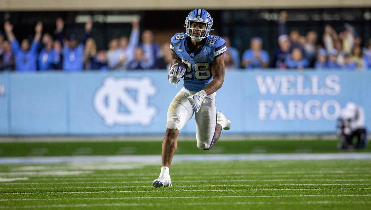 North Carolina running back Omarion Hampton (28) breaks into the open field for a 60-yard carry in the fourth quarter against Miami on Saturday, October 14, 2023 at Kenan Stadium in Chapel Hill, N.C. Hampton rushed for 197 yards and one touchdown in the Tar Heels’ 41-31 victory.