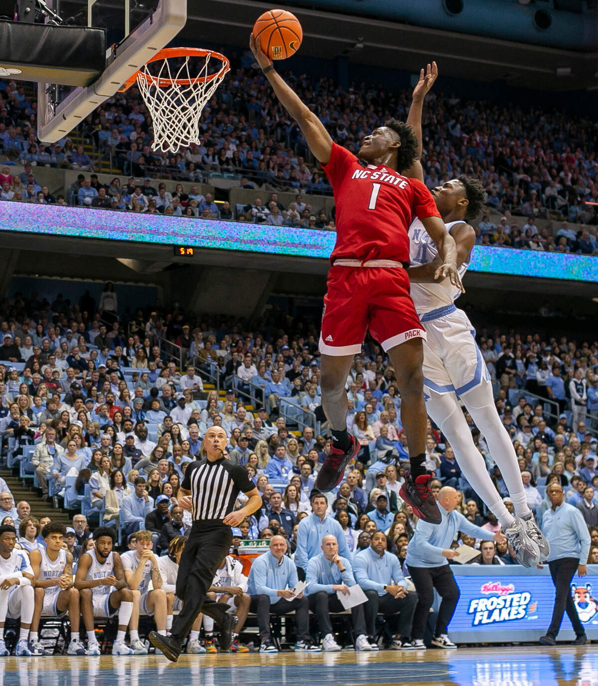 N.C. State’s Terquavion Smith (0) drives to the basket against North Carolina’s D’Marco Dunn (11) during the first half on Saturday, January 21, 2023 at the Smith Center in Chapel Hill, N.C.