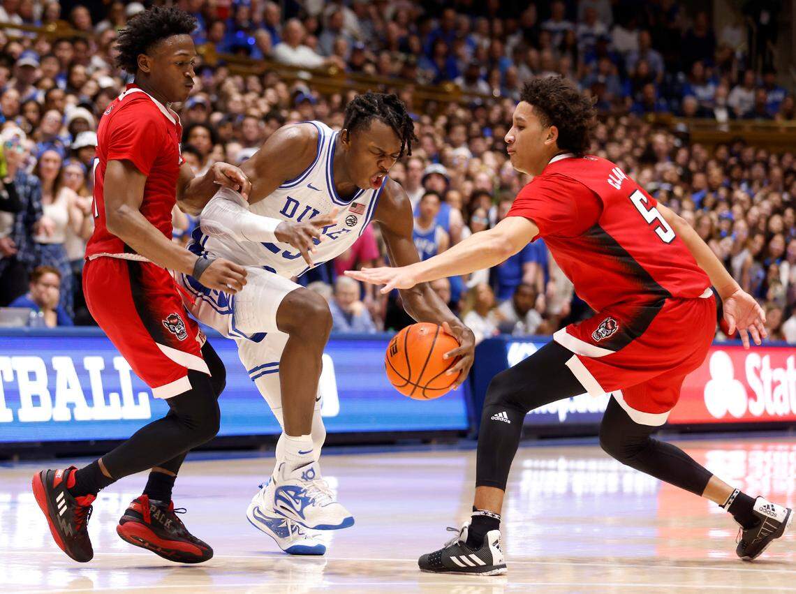 Duke’s Mark Mitchell drives between N.C. State’s Jarkel Joiner and Jack Clark during the second half of Duke’s 71-67 win over N.C. State on Tuesday, Feb. 28, 2023, at Cameron Indoor Stadium in Durham, N.C.