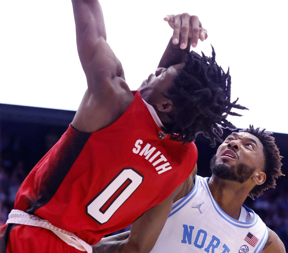 North Carolina’s Leaky Black (1) fouls N.C. State’s Terquavion Smith (0), causing him to fall to the floor and be injured during the second half of UNC’s 80-69 victory over N.C. State at the Smith Center in Chapel Hill, N.C., Saturday, Jan. 21, 2023.