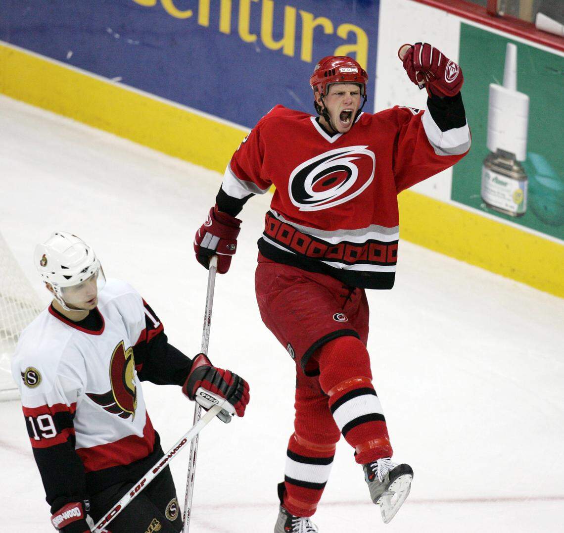 Eric Staal (12) celebrates the Hurricanes' first goal against Ottawa making the score 2-1 as Jason Spezza (19, left) reacts at the RBC Center on Nov. 22, 2005.