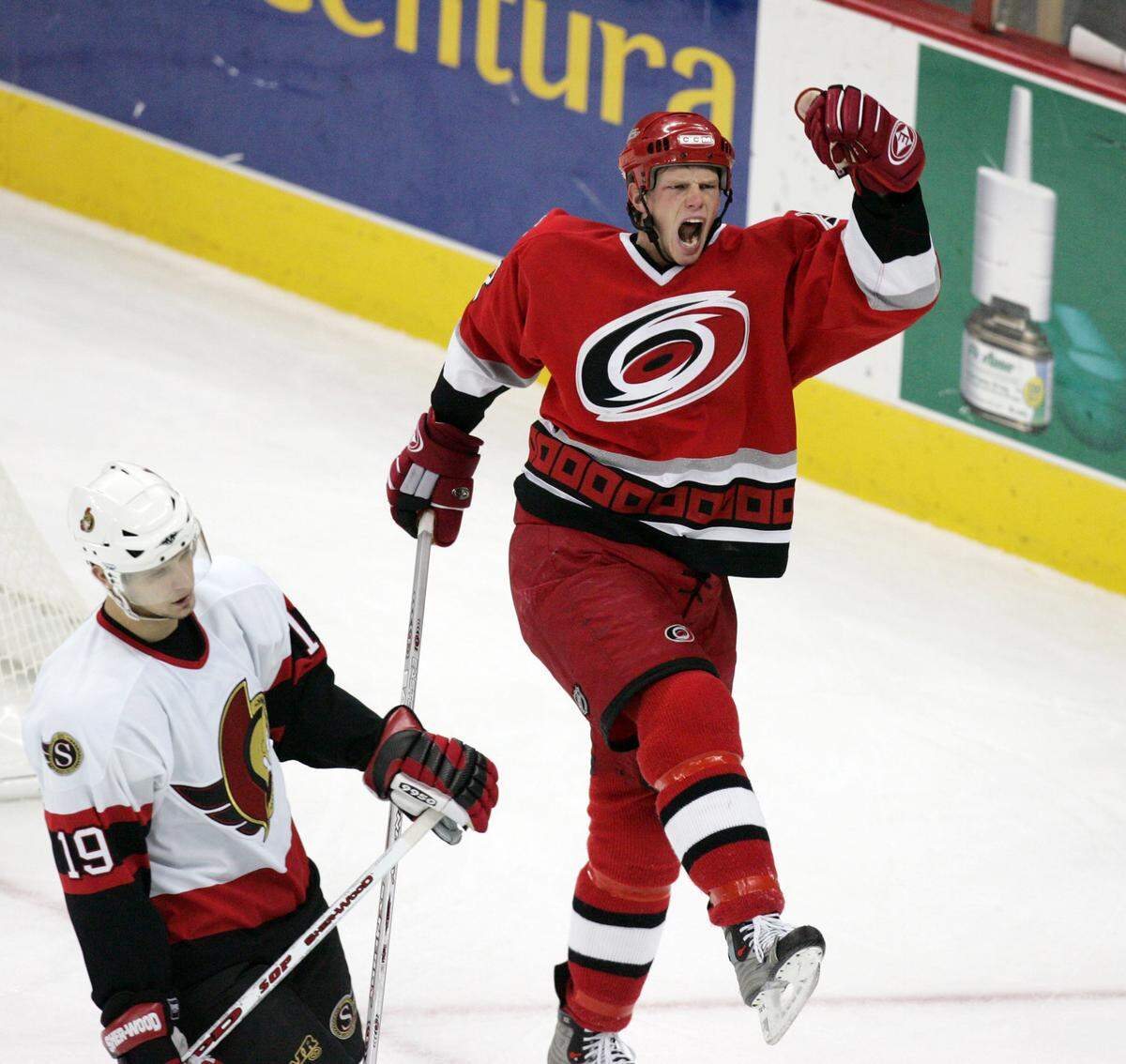 Eric Staal (12) celebrates the Hurricanes' first goal against Ottawa making the score 2-1 as Jason Spezza (19, left) reacts at the RBC Center on Nov. 22, 2005.