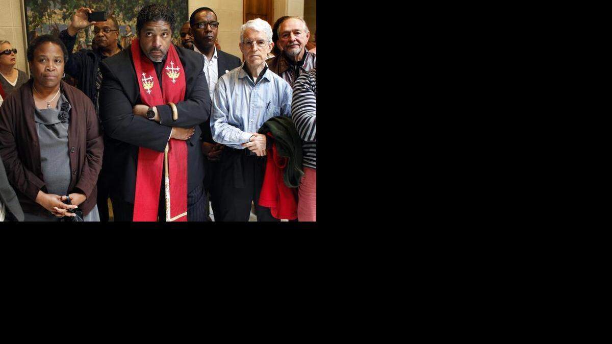The Rev. William Barber II, center, and fellow protesters take a stand against Republican policies last year at the Legislative Building in Raleigh.
